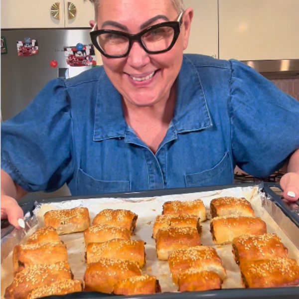 Sausage Rolls holding and cooked on tray