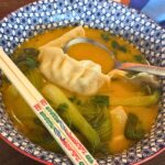 red curry dumpling soup in bowl