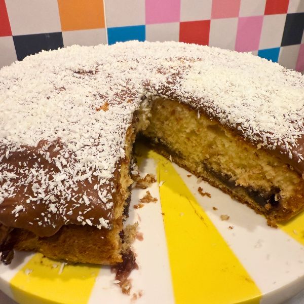lamington cake sliced and on cake stand