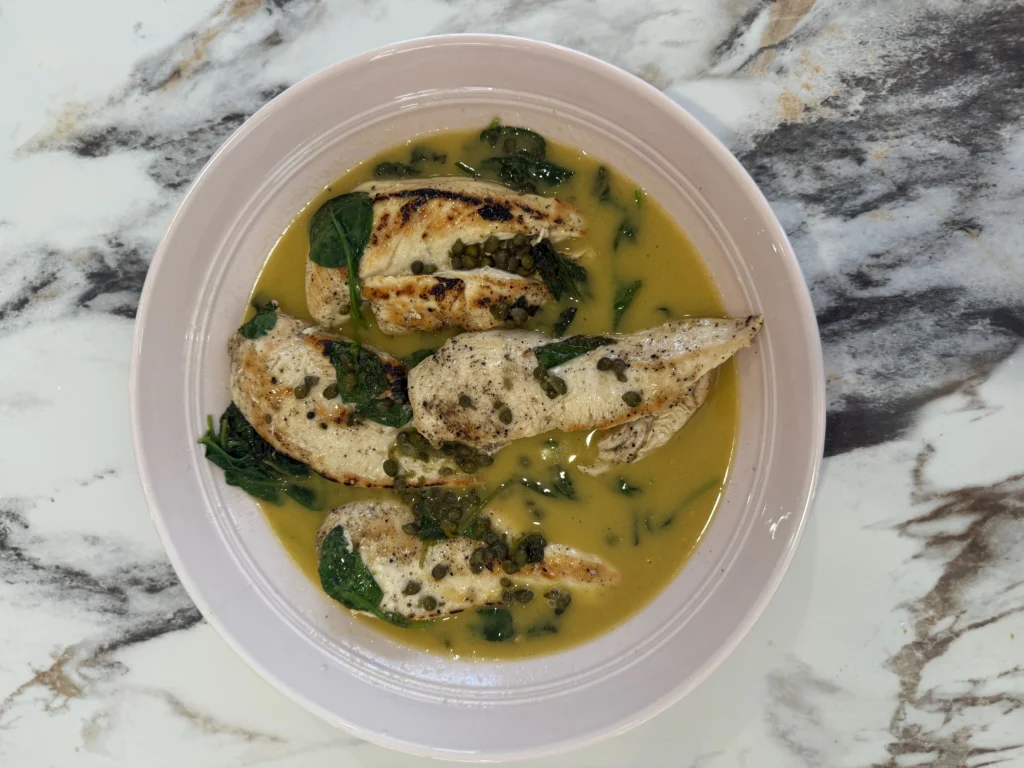 Chicken piccata with lemon butter sauce, capers and spinach