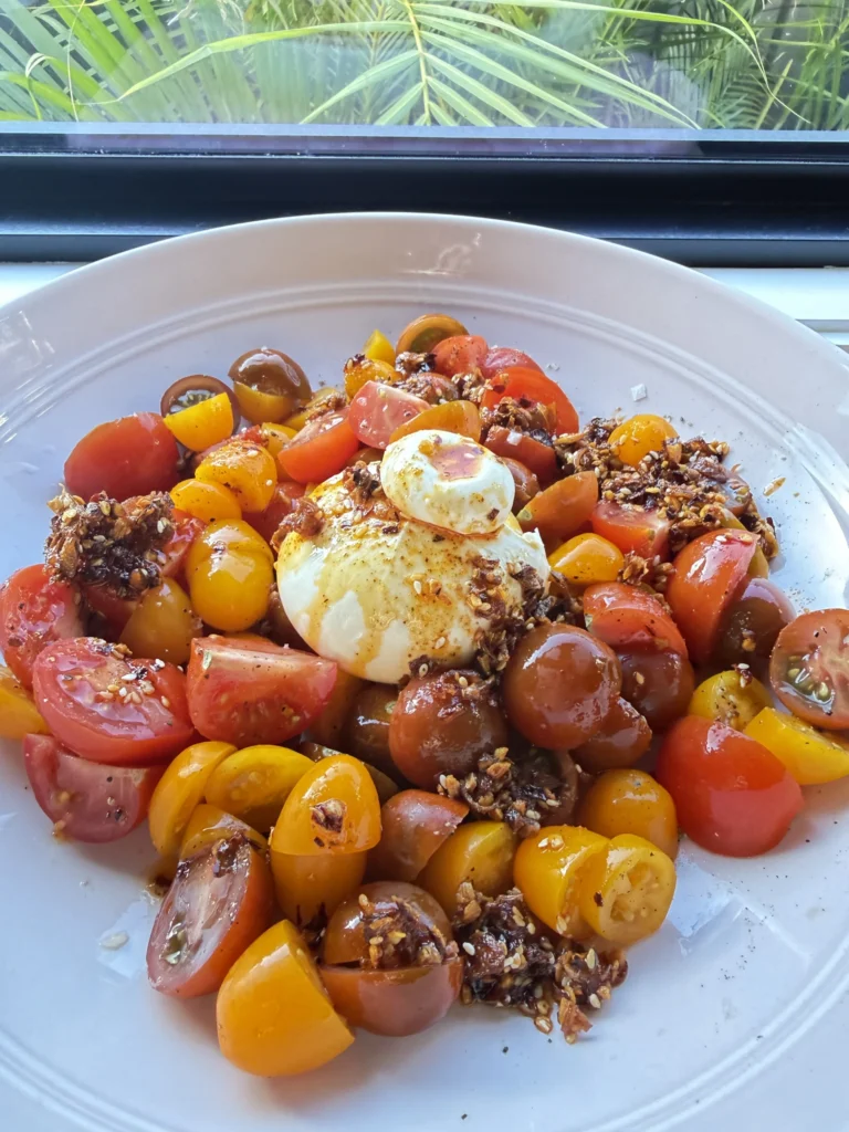 Sunshine salad with tomatoes, burrata and chilli crisp