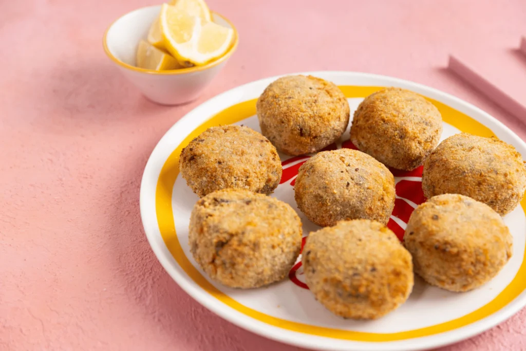 Golden sushi salmon patties served with lemon