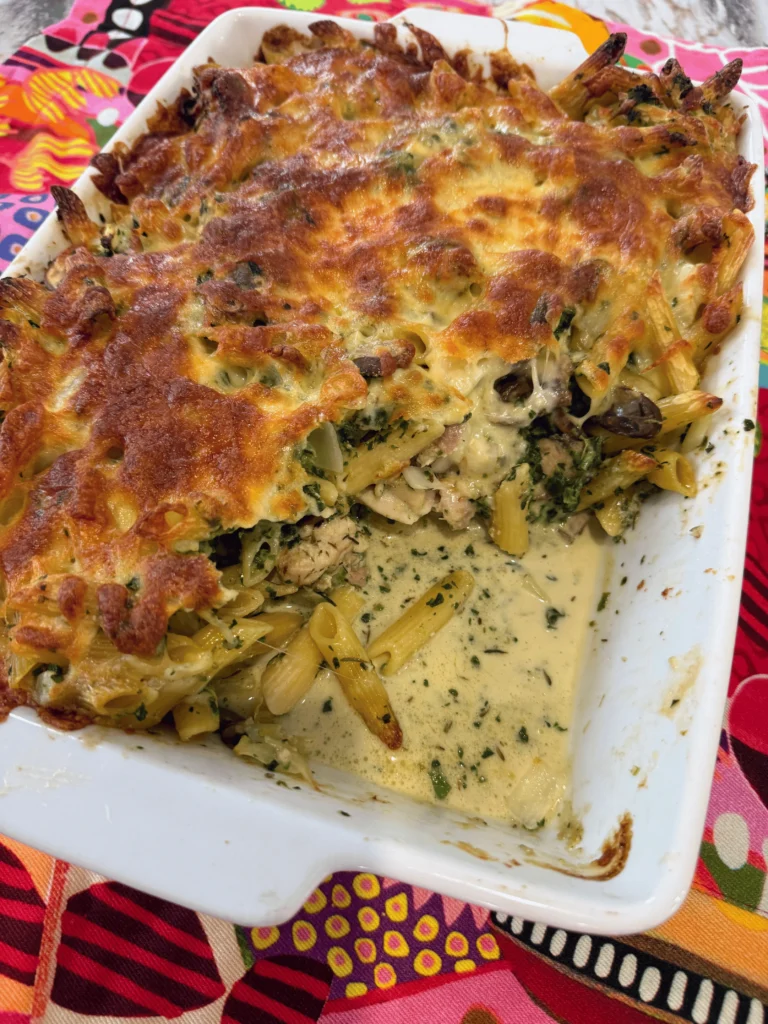 Chicken mushroom pasta bake with penne, spinach and melted cheese