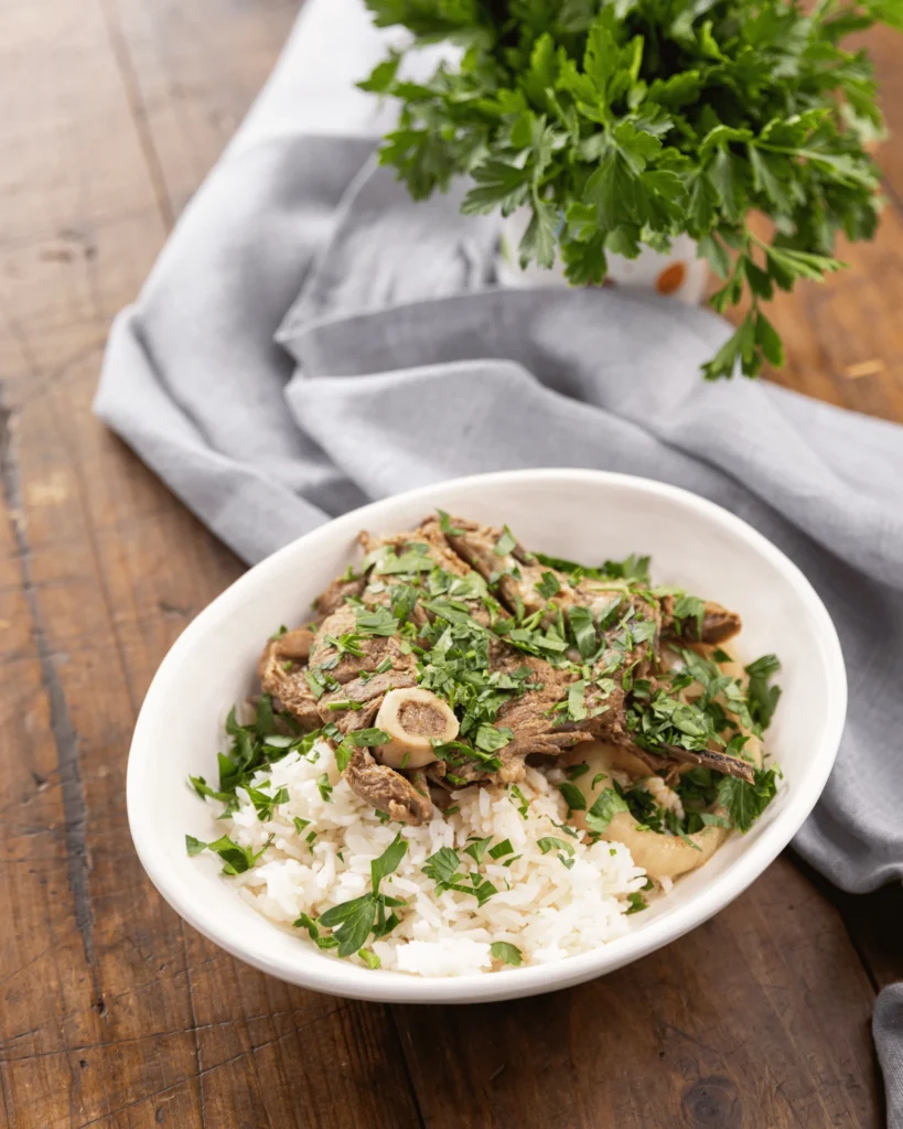 Slow cooked lamb loin chops served over soft onions with rice and Greek yoghurt